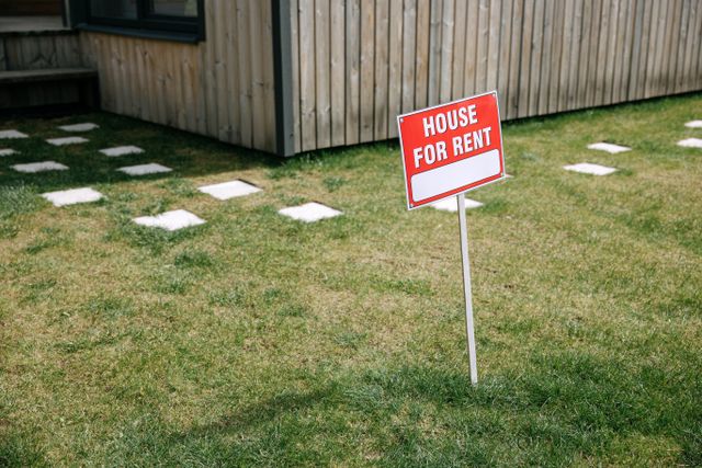 for rent sign on a green lawn