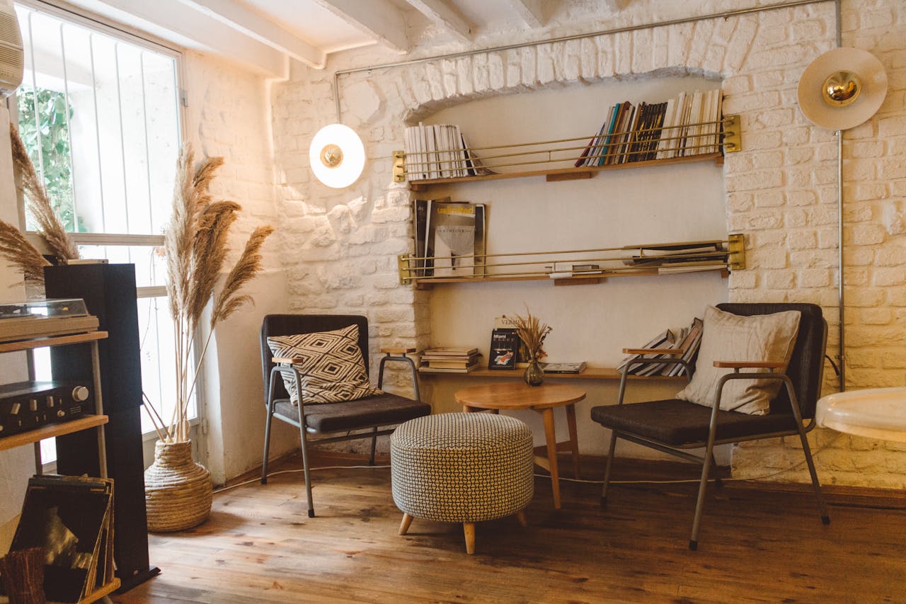 living room with white stone wall and bookshelf